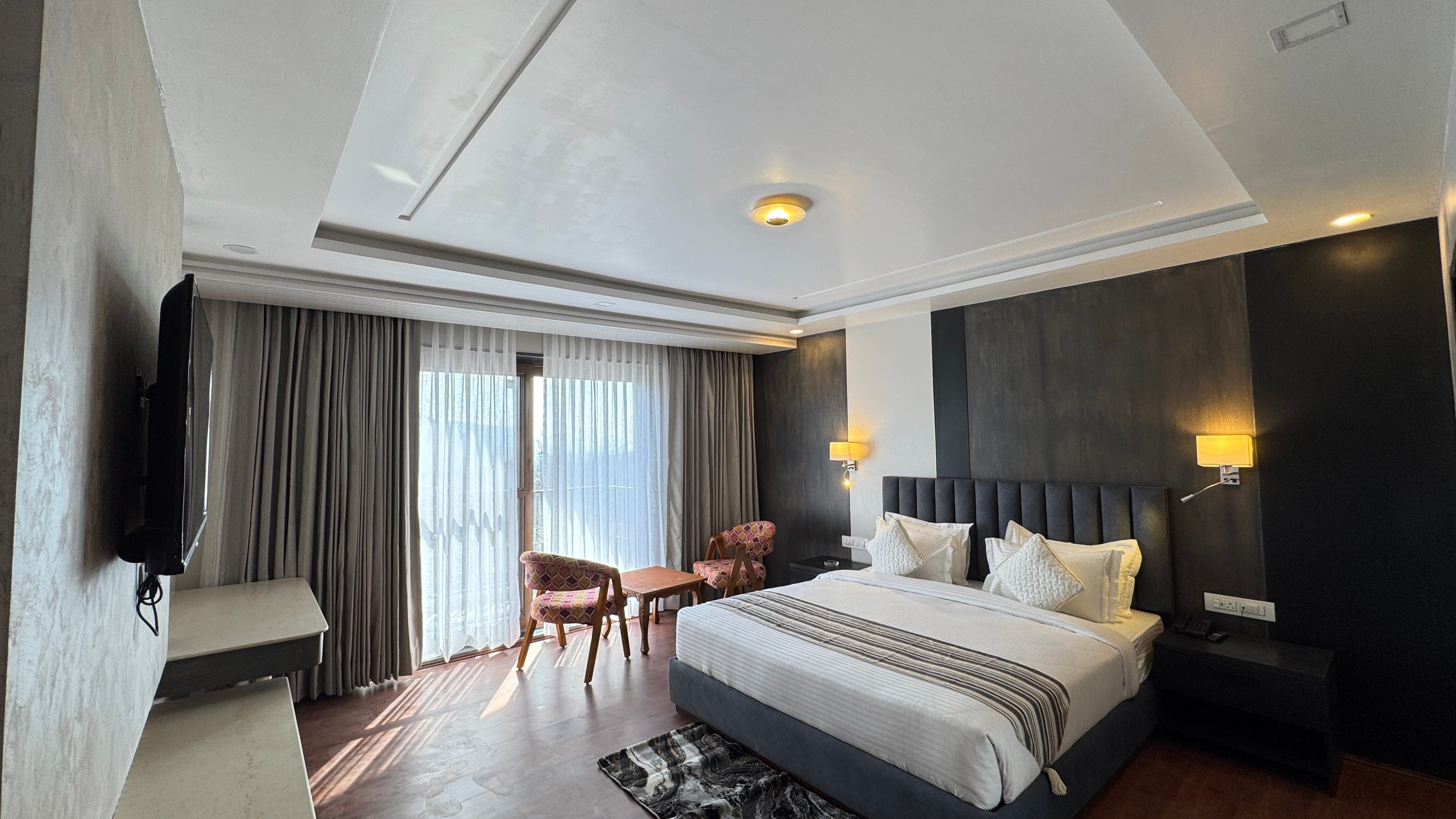 Room with TV wall, window and balcony view