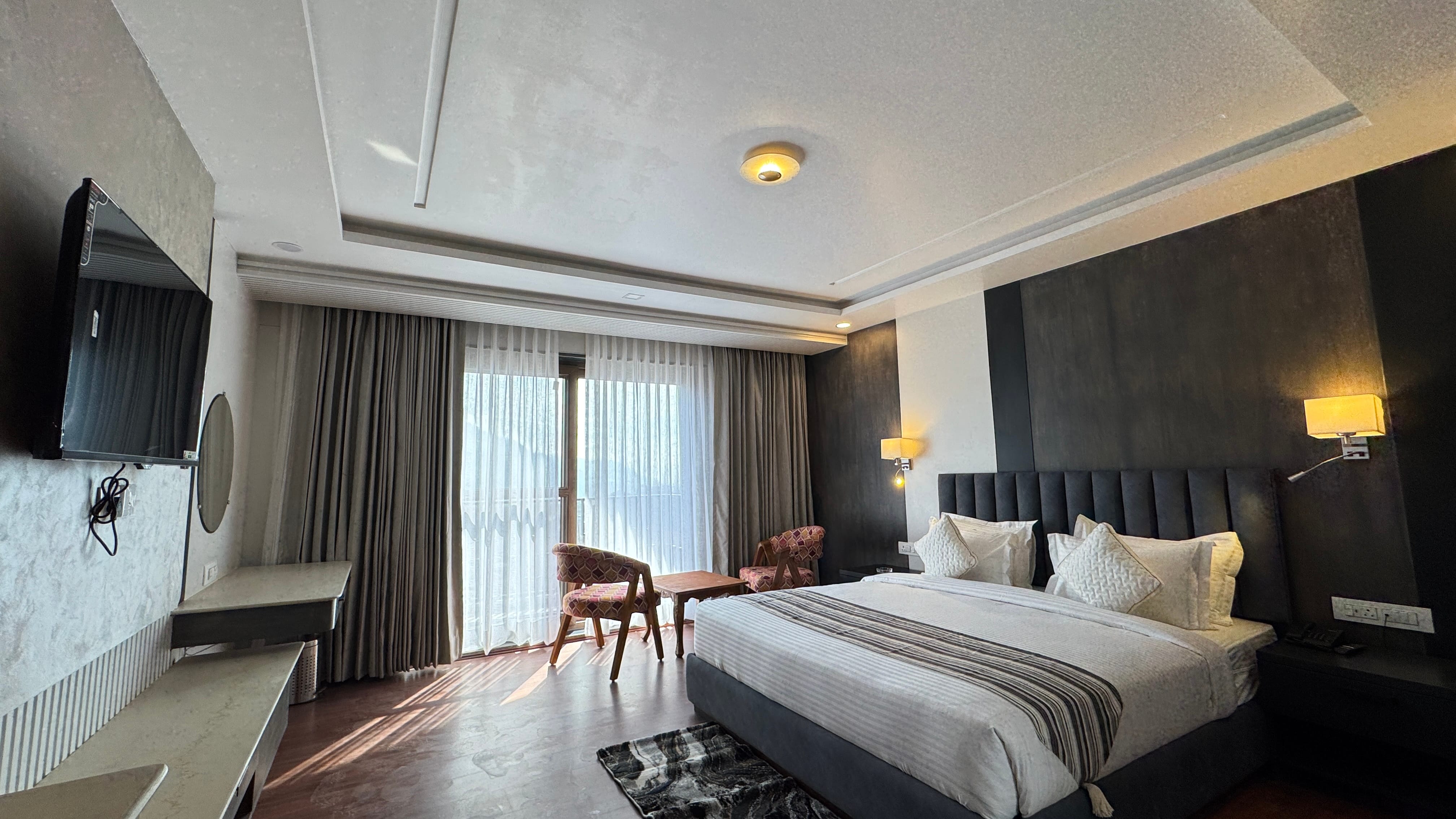 Room with TV and dark headboard wider shot