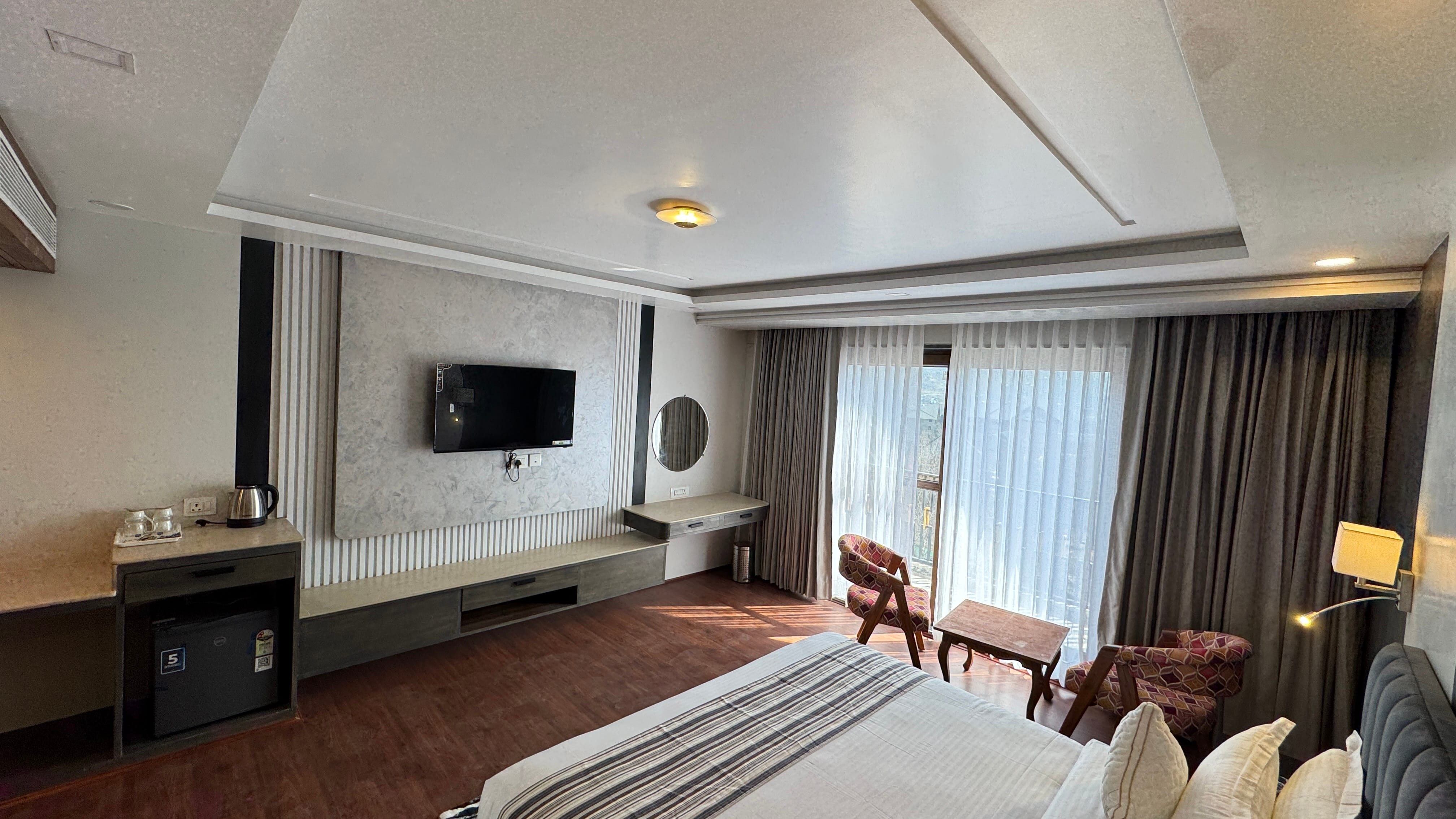 Room with TV wall, balcony window and seating