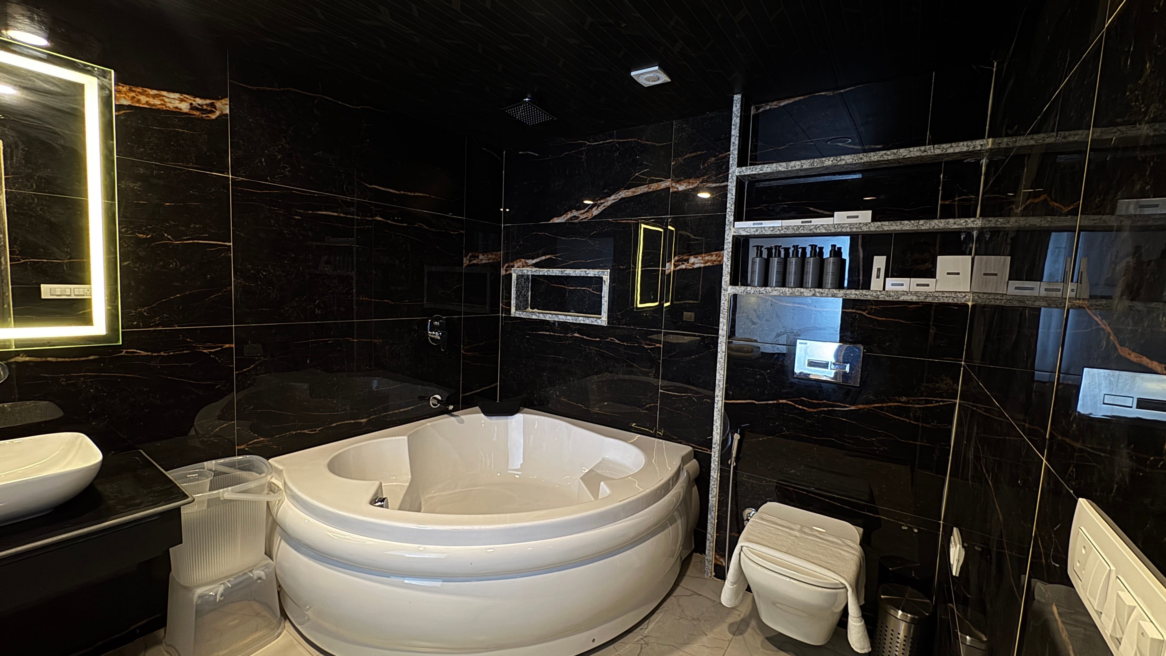 Luxury Jacuzzi Suite with black marble bathroom
