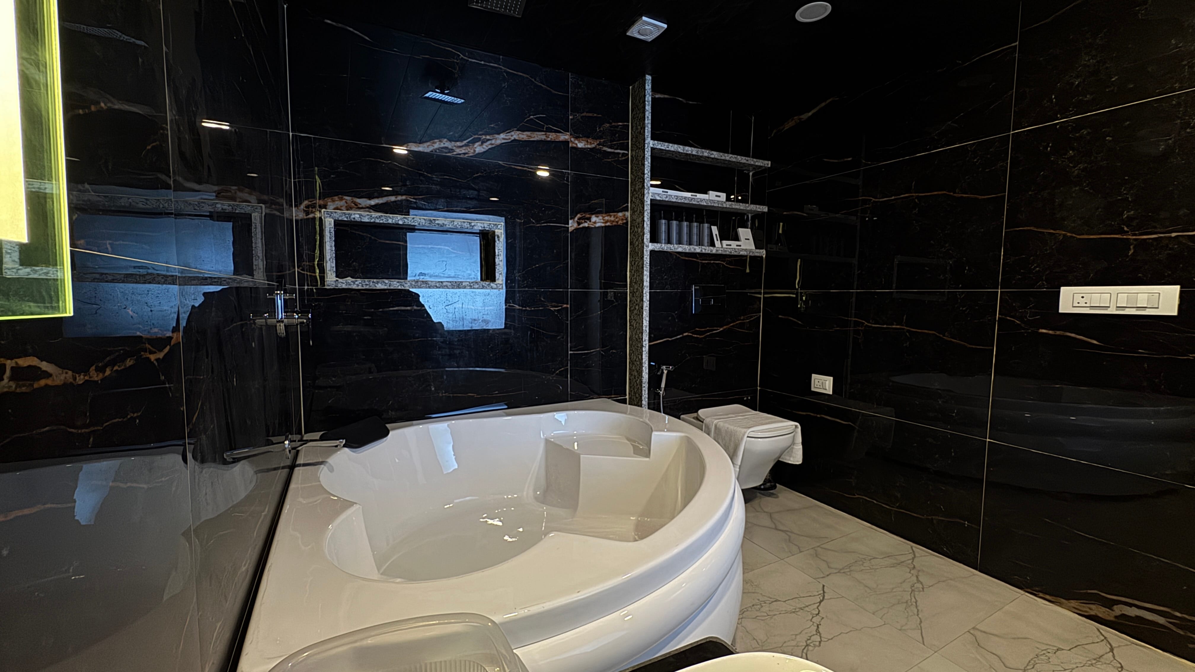 Jacuzzi tub with water in marble bathroom