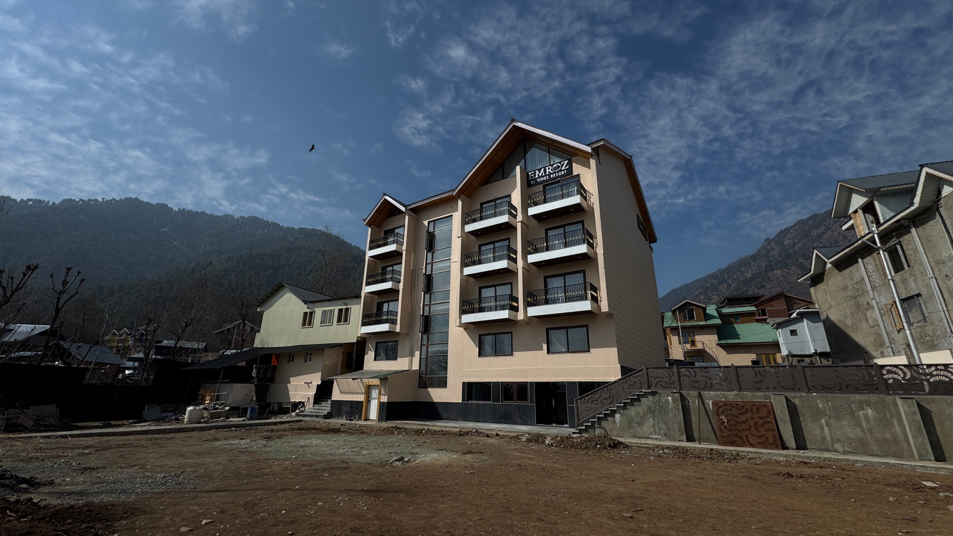 Emroz by Kings Resort building with Emroz signage and Himalayan mountains in the background