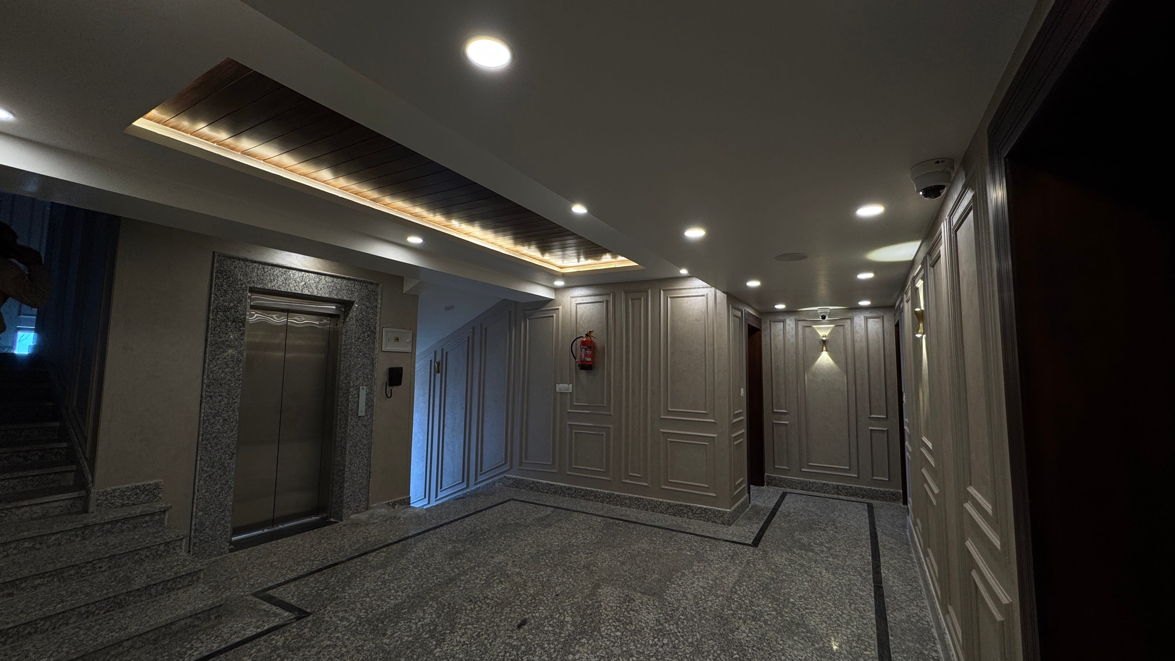 Emroz by Kings Resort lobby area with elevator and warm evening lighting
